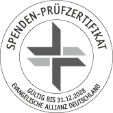 Eine runde deutsche Spendenplakette mit geometrischem Kreuz, gültig bis 31.12.2028.